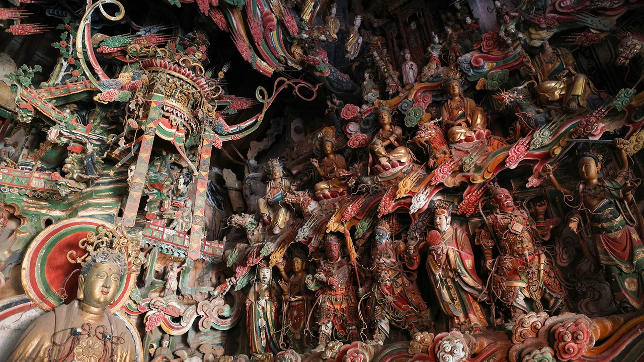 Painted Ming hanging sculptures crowding the wall and beams inside the Guanyin Hall in Changzhi, Shanxi.