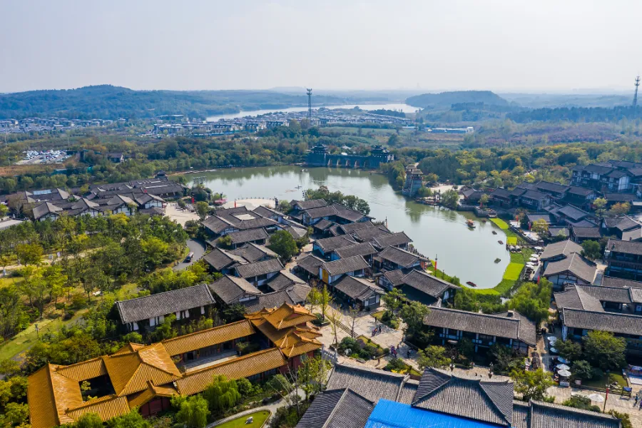A canal with willow trees and old buildings, used as a visual reference for the water landscape around Yancheng's old moats.