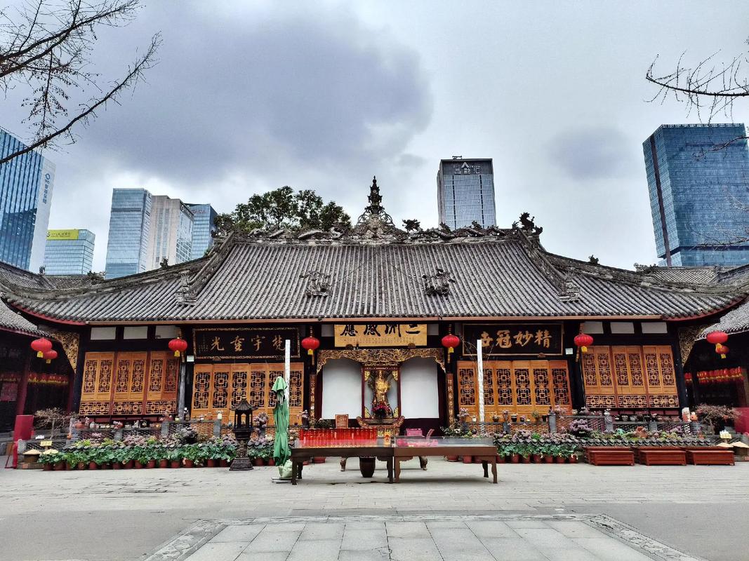 Sleek glass boutique facades sit adjacent to the traditional red brick walls and curved eaves of Daci Temple.