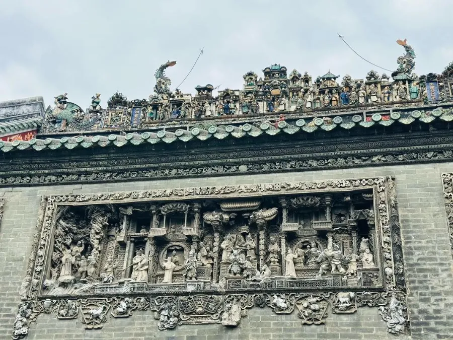 Intricate ceramic ridge decorations and brick carvings on the roof of Chen Clan Academy.