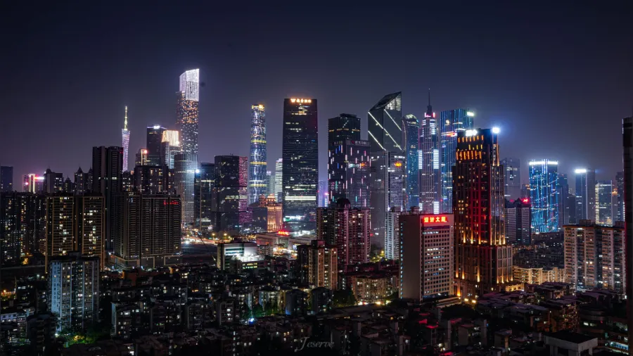 The modern skyline of Guangzhou with the Canton Tower rising along the Pearl River.