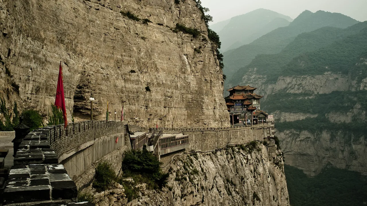Temple buildings and walkways clinging to the sheer cliffs of Mianshan near Jiexiu.