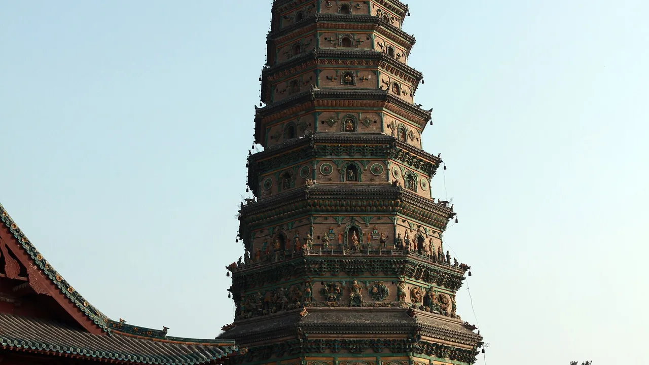 The glazed-tile Flying Rainbow Pagoda at the Upper Guangsheng Temple under a clear sky.