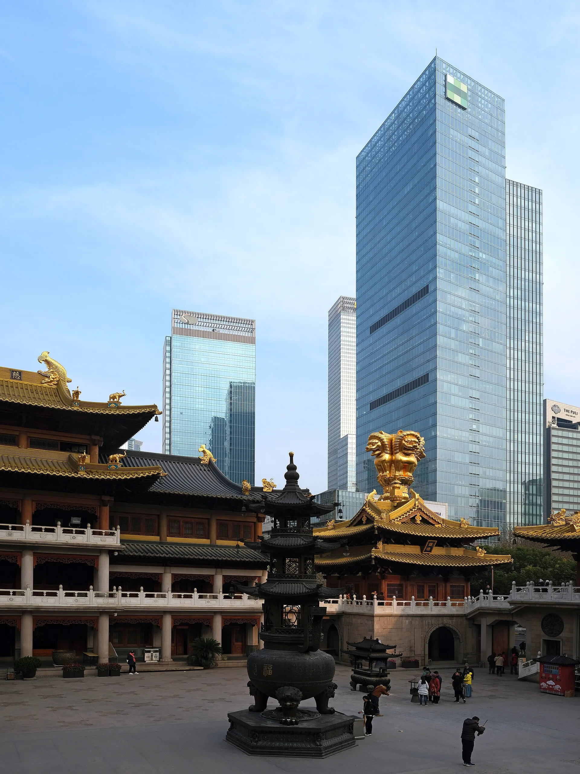Golden roofs of Jing'an Temple against surrounding towers