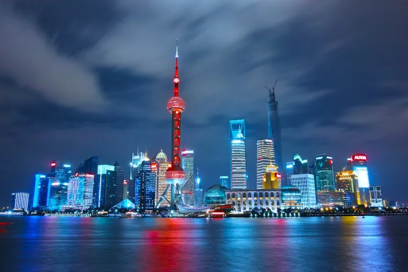 The illuminated skyline of Pudong seen across the Huangpu River from the Bund at night.