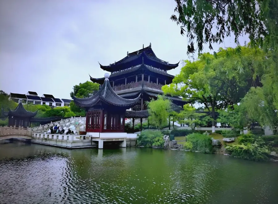 The stone towers and arched water gate of Panmen standing over the quiet canal in Suzhou.