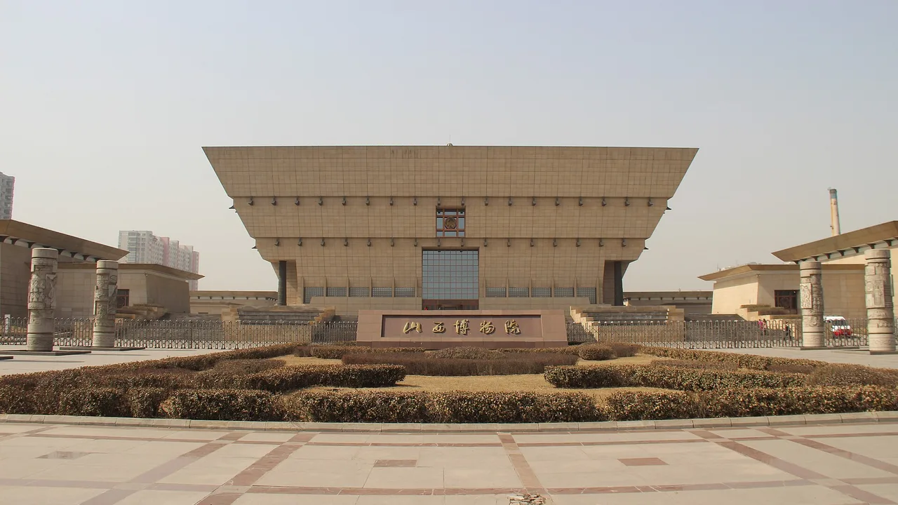 The stepped, vessel-shaped main building of the Shanxi Museum in Taiyuan seen across its forecourt.