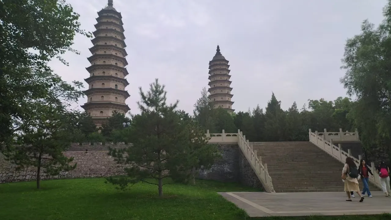 The two Ming brick pagodas of Yongzuo (Shuanta) Temple rising above trees in Taiyuan.