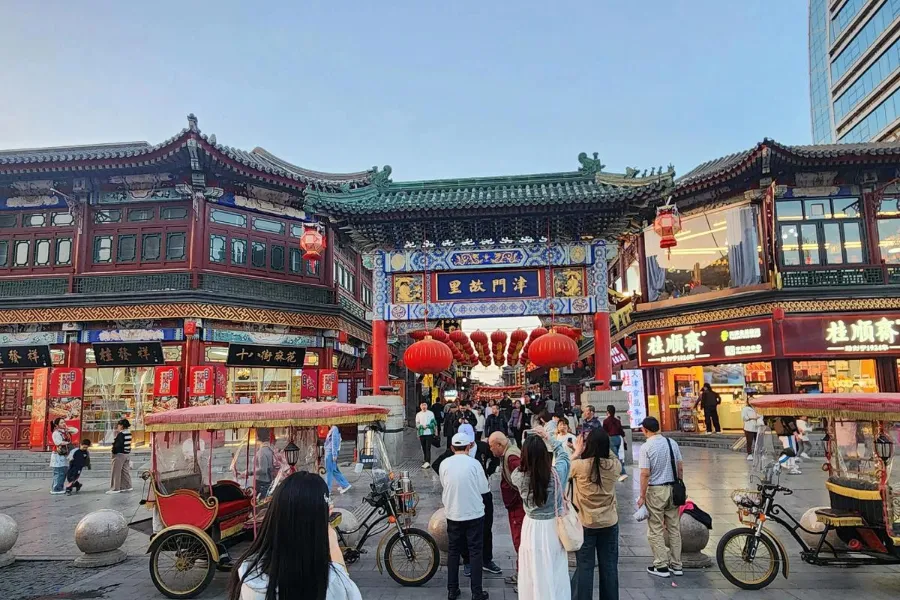 Hand-painted woodblock prints and traditional clay figurines displayed inside a historical shopfront along Ancient Culture Street in Tianjin.