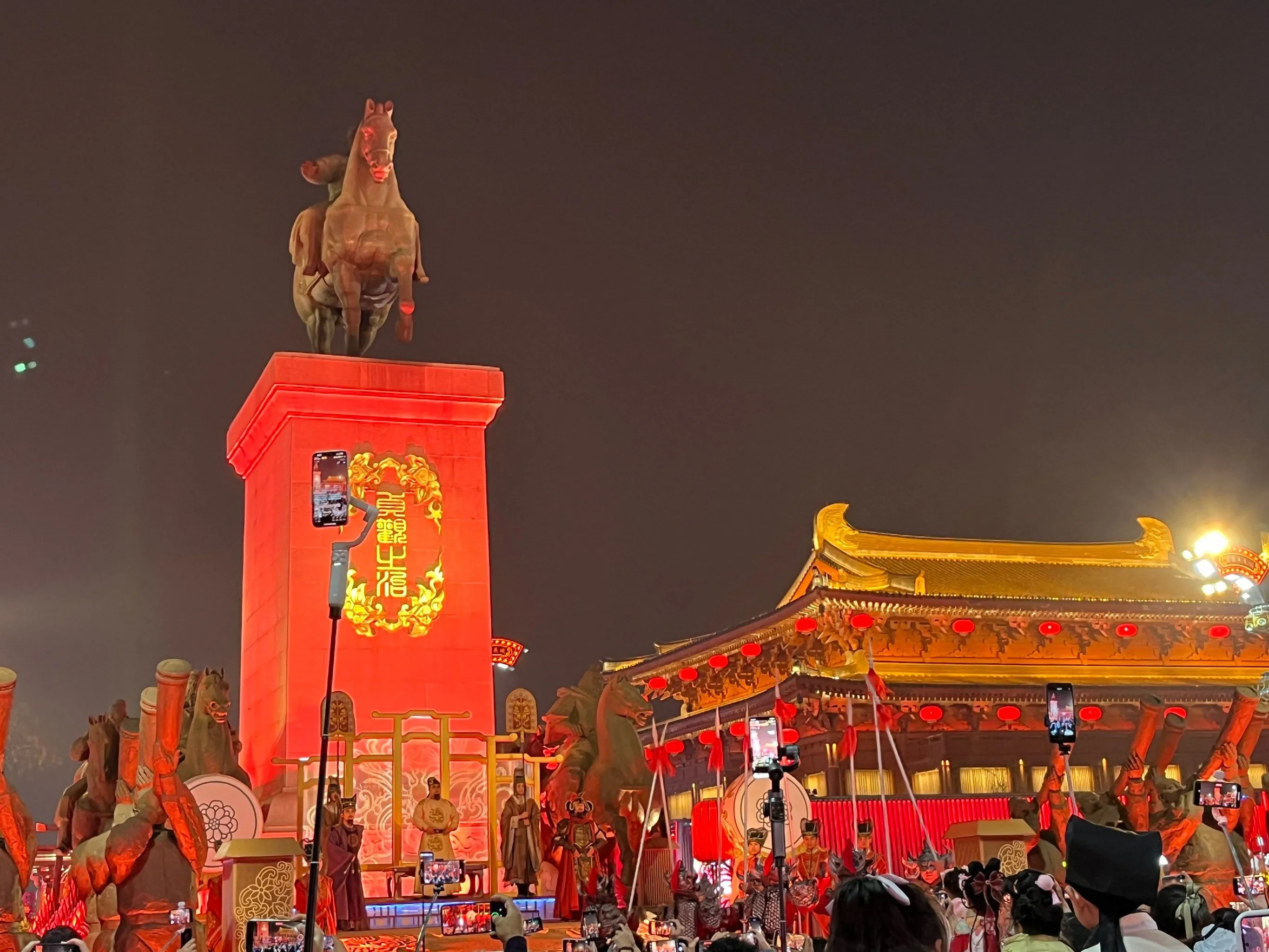 Brilliant red lanterns and neon lights illuminate the Great Tang All Day Mall at night.