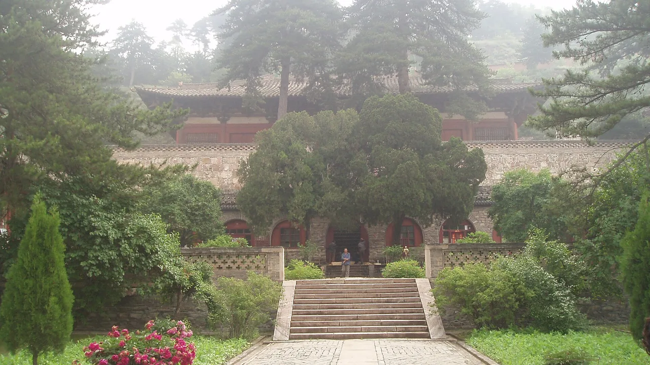 Stone path and stairway climbing through trees to Foguang Temple's East Hall terrace on the hillside.