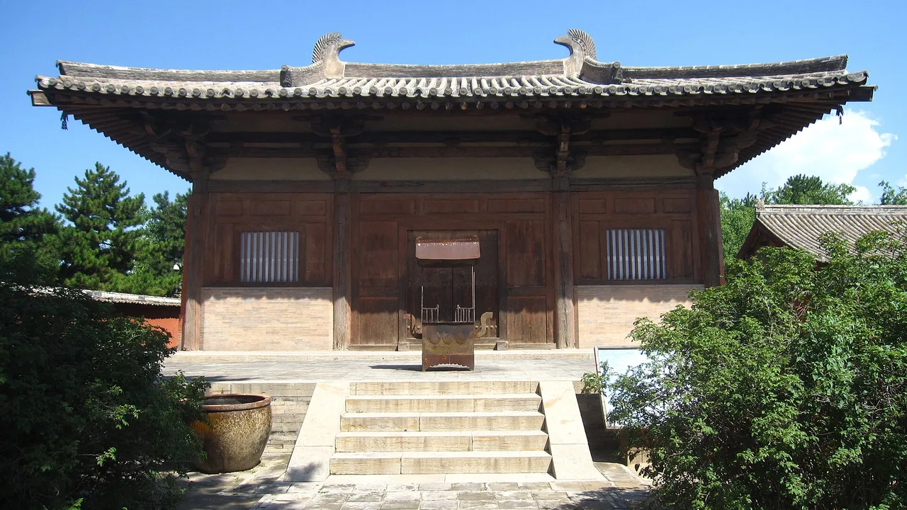 Nanchan Temple's Tang main hall, a small three-bay timber building with a low hip-and-gable roof, on its terrace.